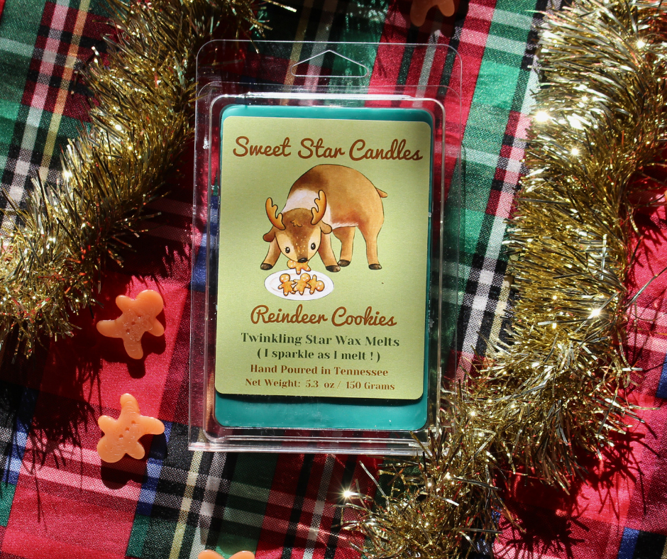 our extra large reindeer cookies soy wax melt sits in a festive background features a Christmas green wax and has a light hunter green label the top reads sweet star candles in light brown cursive letters under that is the animal it is a reindeer eating gingerbread cookies from a plate he glances up with a cookie in his mouth under that reads the title reindeer cookies under that reads sparkle as i melt wax melt hand poured in east Tennessee 5.3 ounces or 150 grams