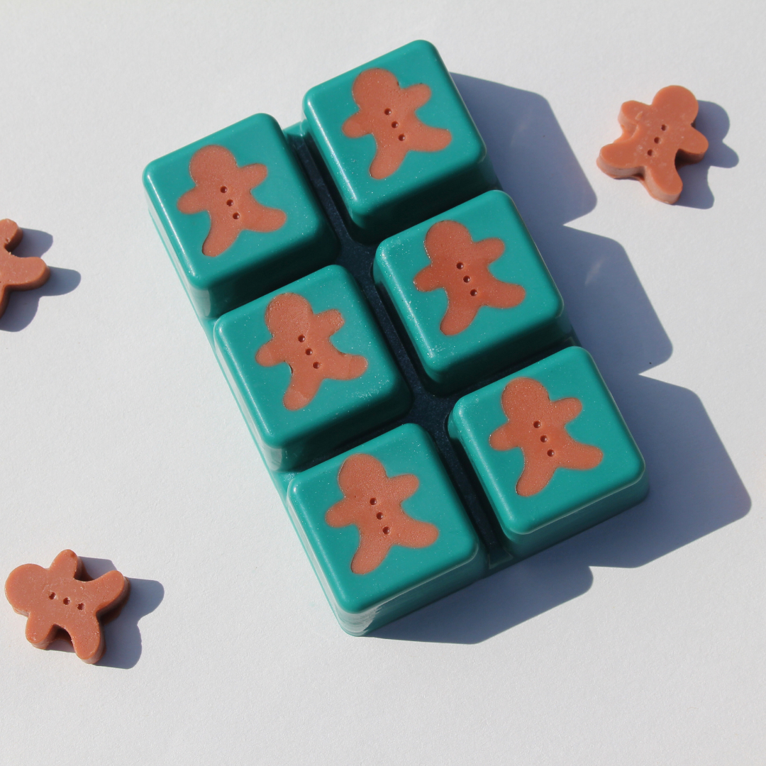 our reindeer cookies wax melt out of the packaging it features gingerbread men in each melt and a Christmas green background color
