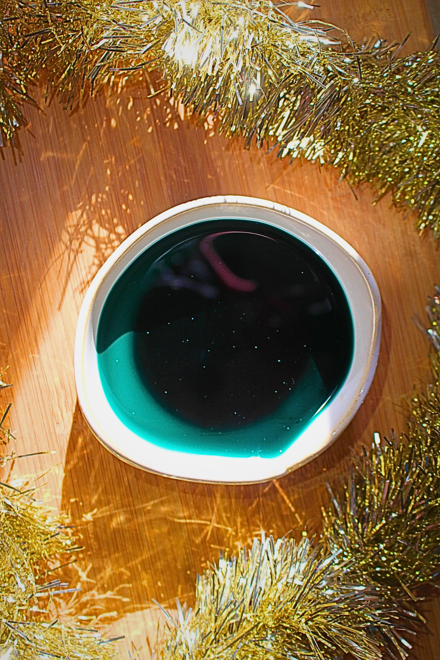 our reindeer cookies wax melt melted in wax warmer with holiday background it sparkles as it melts in the warmer in green wax