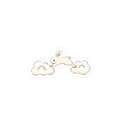 A small illustrated sticker or decal showing a cream-colored bunny jumping between two soft pastel clouds on a plain white background.