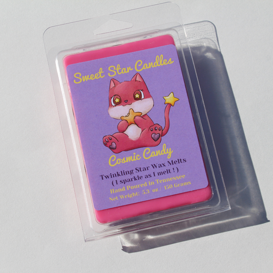 our cosmic candy extra large wax melt has pink wax and clear clamshell with a light purple label on top the top of the label reads sweet star candles in light yellow text under the title our brand mascot can be seen eating a star it is a pink creature with cat ears and has a yellow star on its tail under the character is the title of the wax melt cosmic candy under the title it says twinkling star wax melts i sparkle as i melt under that it lets you know it is hand poured in east Tennessee and is 5.3 ounces
