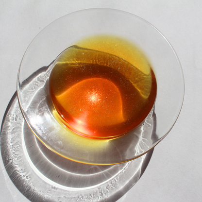 our pumpkin patch cat wax melt fully melted it has a bright orange soy wax in the wax warmer with small sparkles inside