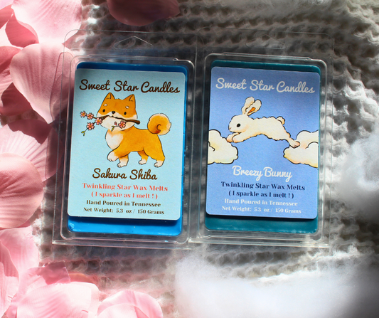 our sakura shiba and breezy bunny 5.4 oz extra large wax melts sit beside each other this bundle is perfect for floral and clean scent lovers who want a blue pop of color in their wax melt