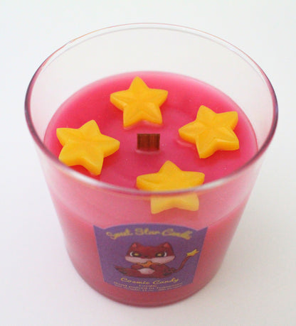 This shows a top view of the candle 4 yellow stars go around the wooden wick in the center of the candle atop the magenta colored candle below